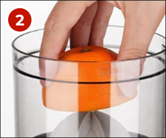 Placing a sliced orange on the juicer