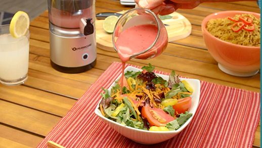 Pouring a cream over a bowl of salad